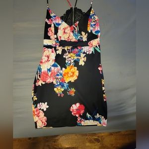 A black floral dress with cut out and lace in the, spaghetti straps.
